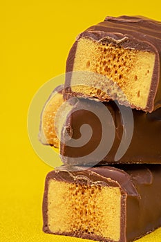 Tasty Stacked Chocolate Honeycomb Treat on yellow background