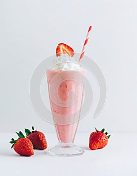 Tasty strawberry milkshake with strawberries on white background
