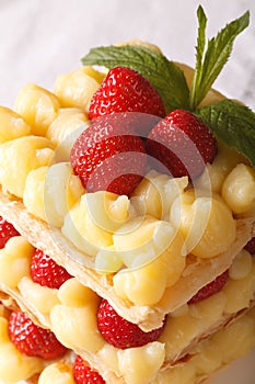 Tasty strawberry millefeuille with custard macro. vertical