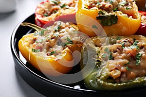 Tasty stuffed bell peppers on table, closeup