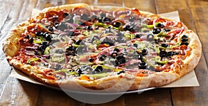 Tasty supreme pizza with olives peppers onions and sausage