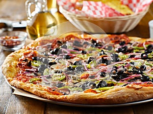 Tasty supreme pizza with olives peppers onions and sausage