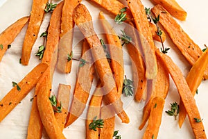 Tasty sweet potato fries on parchment