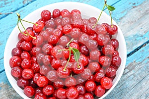 Tasty sweet ripe red cherries in a bowl as a concept of high quality vitamin food and healthy eating. Cherries background