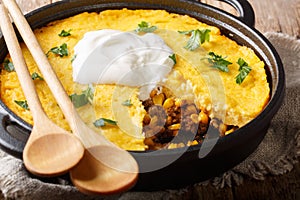 Tasty Tamale pie with corn and ground beef and cheese closeup in a pan. horizontal photo