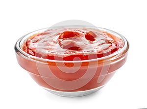 Tasty tomato sauce in glass bowl on white background