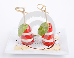 Tasty tomatoe mozzarella salad with basil on white