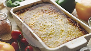 Tasty traditional italian lasagna with bolognese, melted and cheese. Served with ingredients