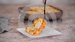 Tasty traditional italian lasagna. Piece of Lasagne on white plate.