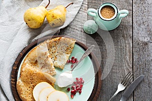 Tasty traditional russian breakfast of pancakes with honey on plate. Rustic style. Copy space.