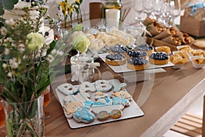 Tasty treats on table in room. Baby shower party