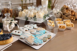 Tasty treats on table in room. Baby shower party