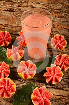 Tasty tropical Indian red guava fruit juice  artistically sliced.