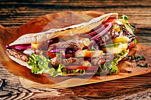 Tasty Turkish doner kebab on toasted tortilla photo