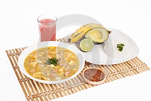 Tasty typical Colombian food; Mondongo of soup with avocado, banana and white rice photo