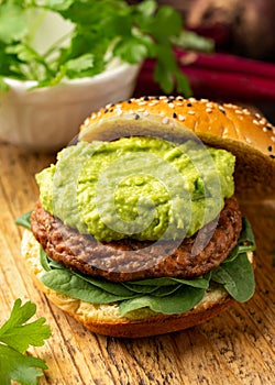 Tasty Vegan meat free burger with guacamole and spinach. Healthy food
