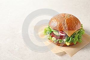 Tasty vegetarian burger with beet cutlet on light background.