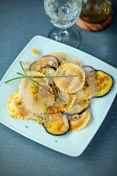 Tasty vegetarian cuisine with ravioli and eggplant photo