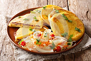 Tasty vegetarian pupusas recipe served with curtido closeup on a plate. horizontal