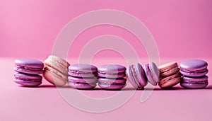 Tasty violet french macarons on a pink pastel background. Place for text