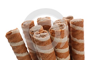 Tasty wafer roll sticks on white background, closeup.