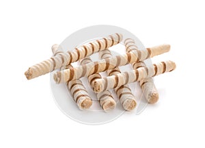 Tasty wafer roll sticks on white background.