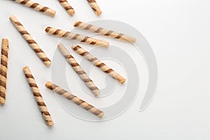 Tasty wafer roll sticks on white background, top view.