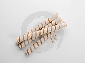 Tasty wafer roll sticks on white background, top view.