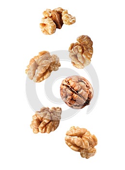 Tasty walnuts falling on background