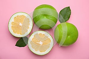 Tasty whole and cut sweeties on pink background, flat lay