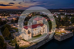 Tata, Hungary - Aerial view of the beautiful illuminated Castle of Tata by the Old Lake Ãâreg-to at dusk with colorful clouds photo
