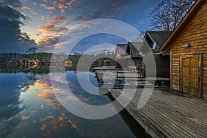 Tata, Hungary - Beautiful sunset over lake Derito Derito to in November with wooden fishing cottages