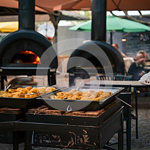 Tatars cooking in ovens at an outdoor cafÃÂ© photo