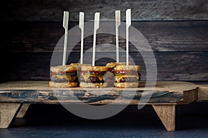 Tater beef slider skewers on a wooden serving board, ready for sharing.