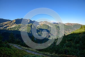 Tatra mountain peaks with tourist hiking trails in sunny summer day