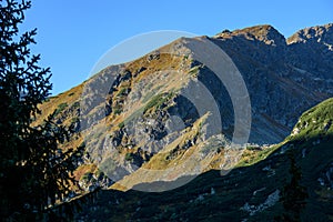 Tatra mountain peaks with tourist hiking trails in sunny summer day