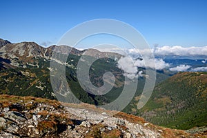 Tatra mountain peaks with tourist hiking trails in sunny summer day