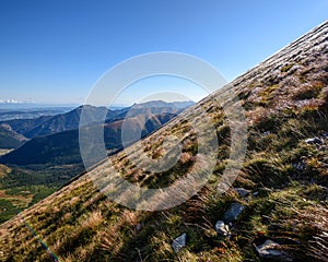 Tatra mountain peaks with tourist hiking trails in sunny summer day