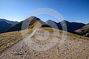 Tatra mountain peaks with tourist hiking trails in sunny summer day