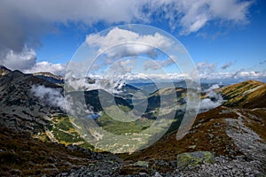 Tatra mountain peaks with tourist hiking trails in sunny summer day