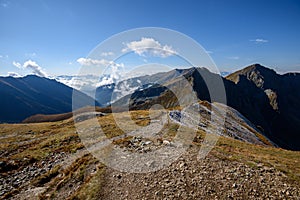 Tatra mountain peaks with tourist hiking trails in sunny summer day