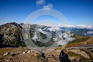 Tatra mountain peaks with tourist hiking trails in sunny summer day