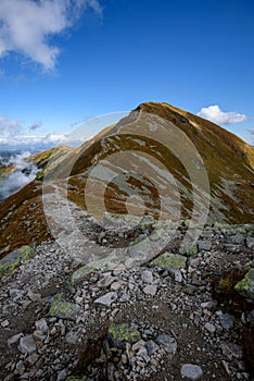 Tatra mountain peaks with tourist hiking trails in sunny summer day