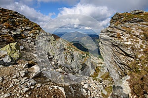 Tatra mountain peaks with tourist hiking trails in sunny summer day