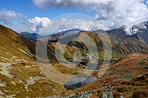 Tatra mountain peaks with tourist hiking trails in sunny summer day