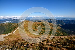 Tatra mountain peaks with tourist hiking trails in sunny summer day