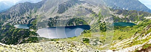 Tatra mountains in Poland, green hill, lake and rocky peak in the sunny day with clear blue sky