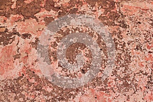 Tatter of a multi-colored old paint on a surface of a stone wall