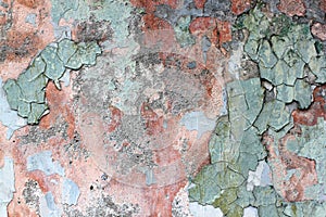 Tatter of a multi-colored old paint on a surface of a stone wall photo