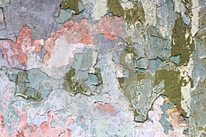 Tatter of a multi-colored old paint on a surface of a stone wall photo